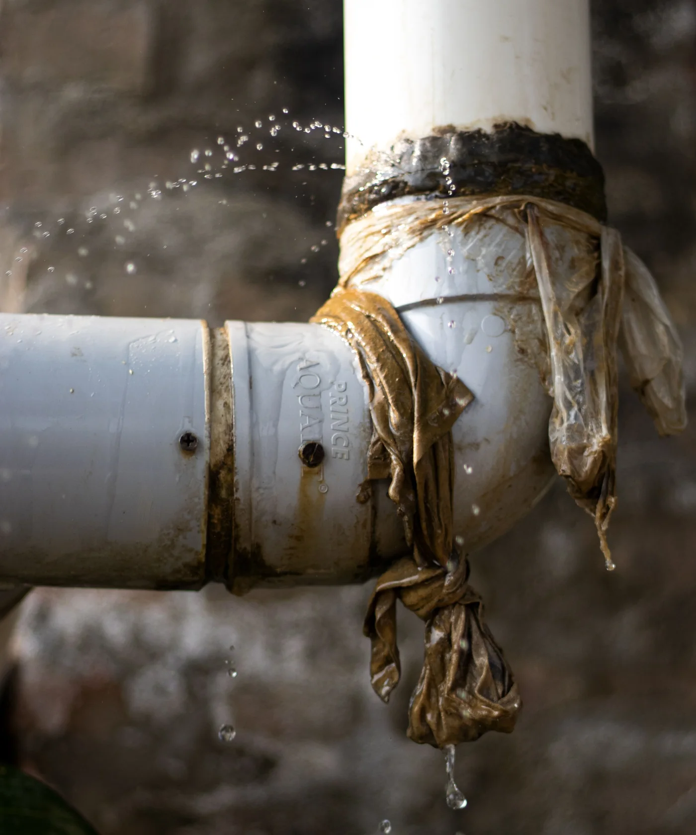 Water leaking from a failing pipe joint